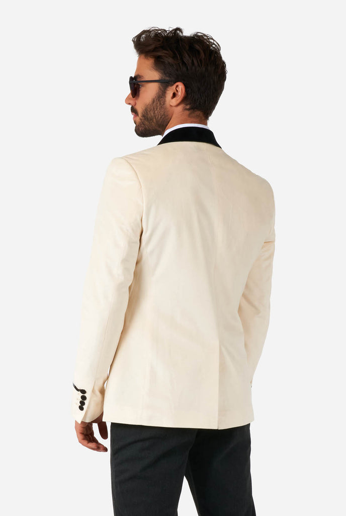 Man wearing ivory white velvet dinner jacket, view from the back