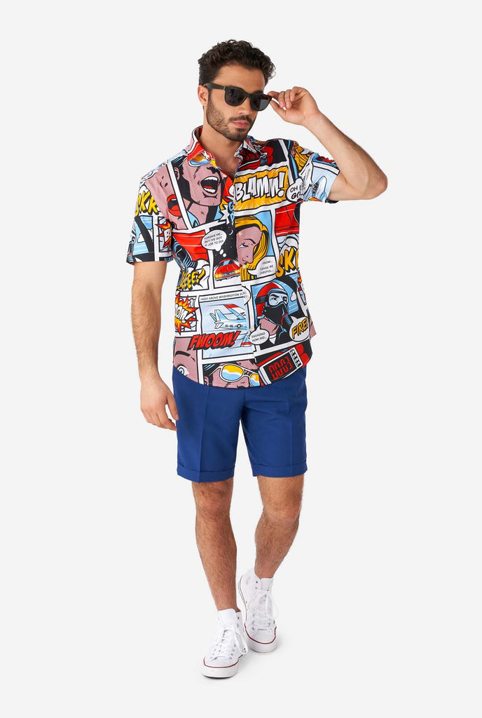 Man wearing summer shirt with Comic book print and blue shorts
