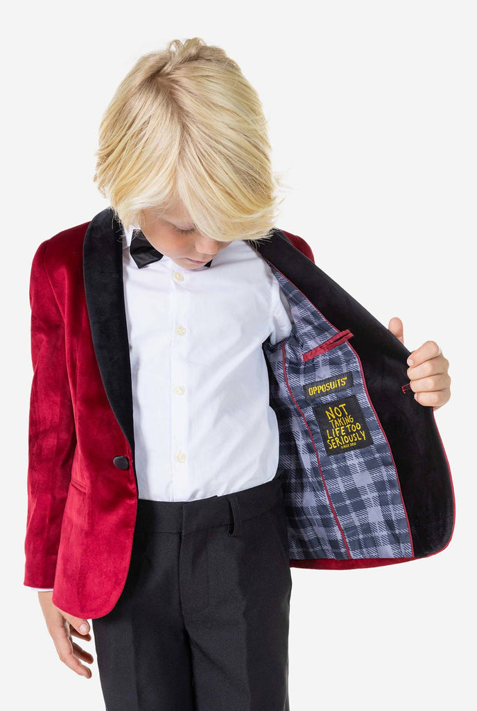 Boy wearing red velvet dinner jacket