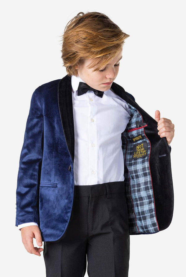 Boy wearing blue velvet Christmas dinner jacket