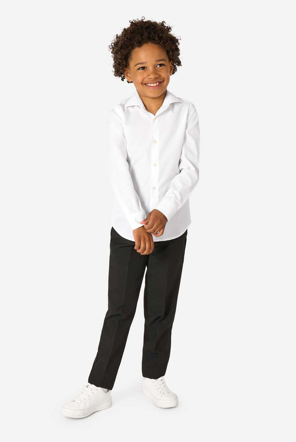 Little kid is wearing a white shirt and a black pants. Full body image