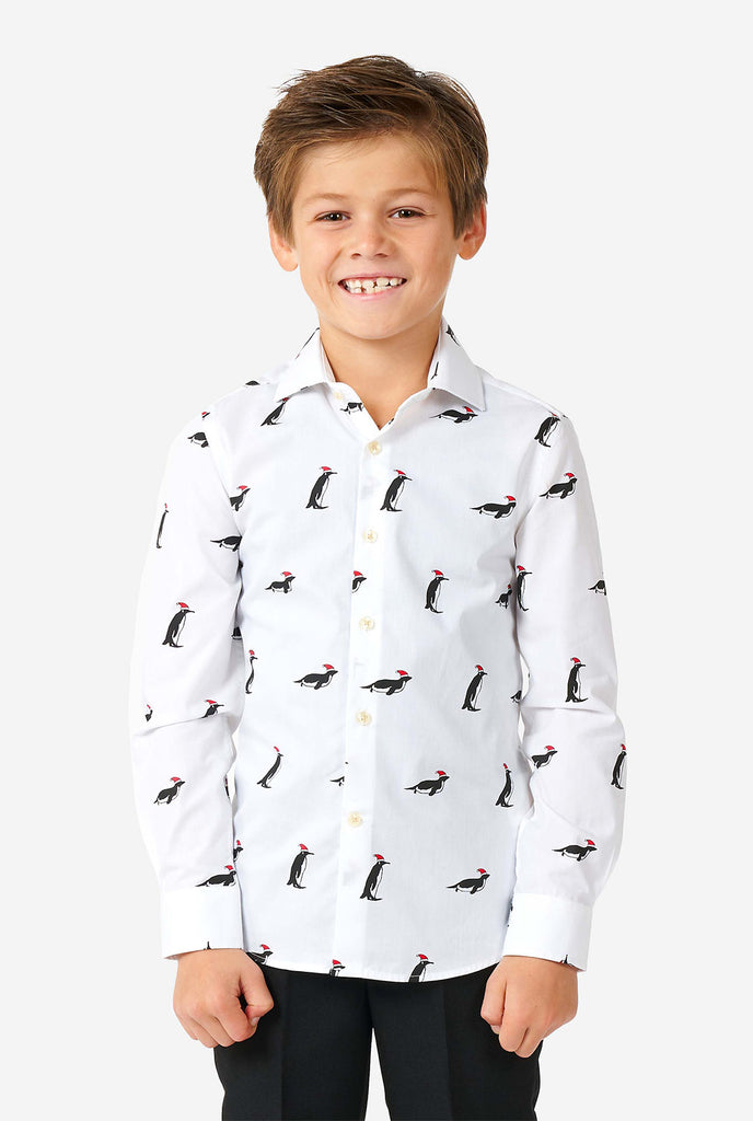 White Christmas dress shirt with Christmas penguins worn by a boy zoomed in