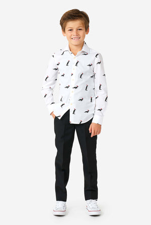 White Christmas dress shirt with Christmas penguins worn by a boy zoomed in