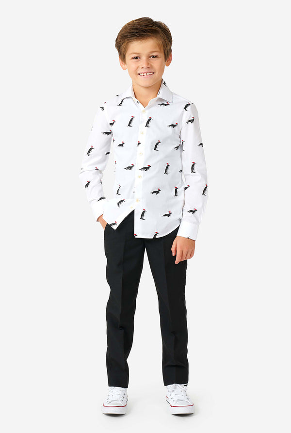 White Christmas dress shirt with Christmas penguins worn by a boy zoomed in