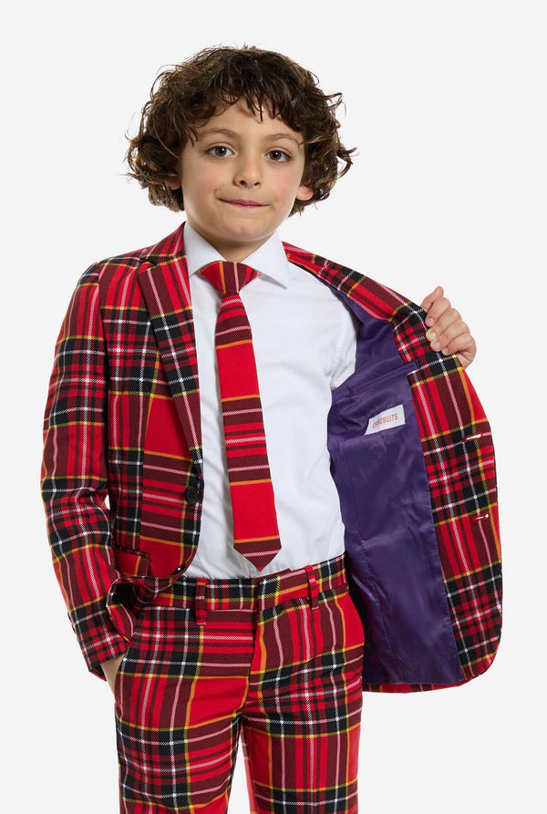 Child wearing a red plaid suit with a white shirt and purple vest.