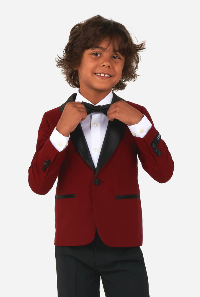 Boy wearing red and black tuxedo