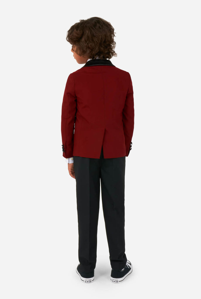 Boy wearing red and black tuxedo, view from the back