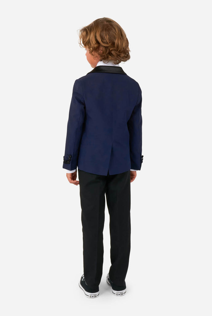 Boy wearing blue and black tuxedo, view from the back