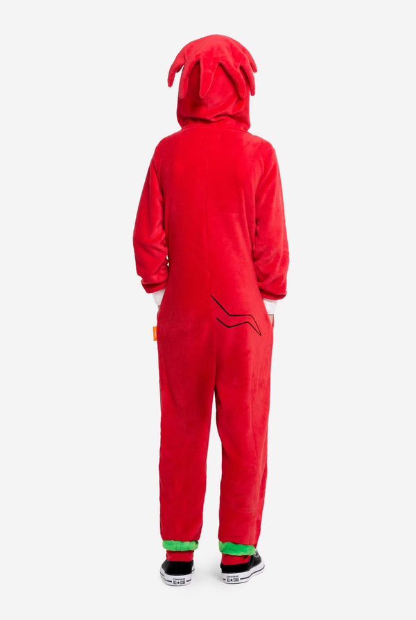 Back view of a child wearing the red Knuckles onesie, showing hood with soft spikes and black printed tail details near the lower back.