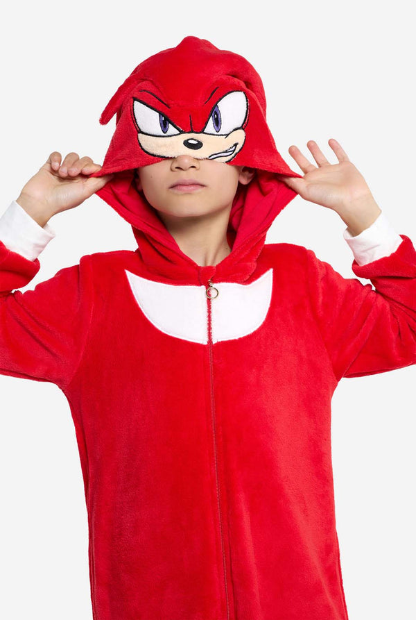 Close-up of a child wearing the Knuckles onesie with the hood partially pulled over their eyes, revealing Knuckles’ embroidered facial expression.