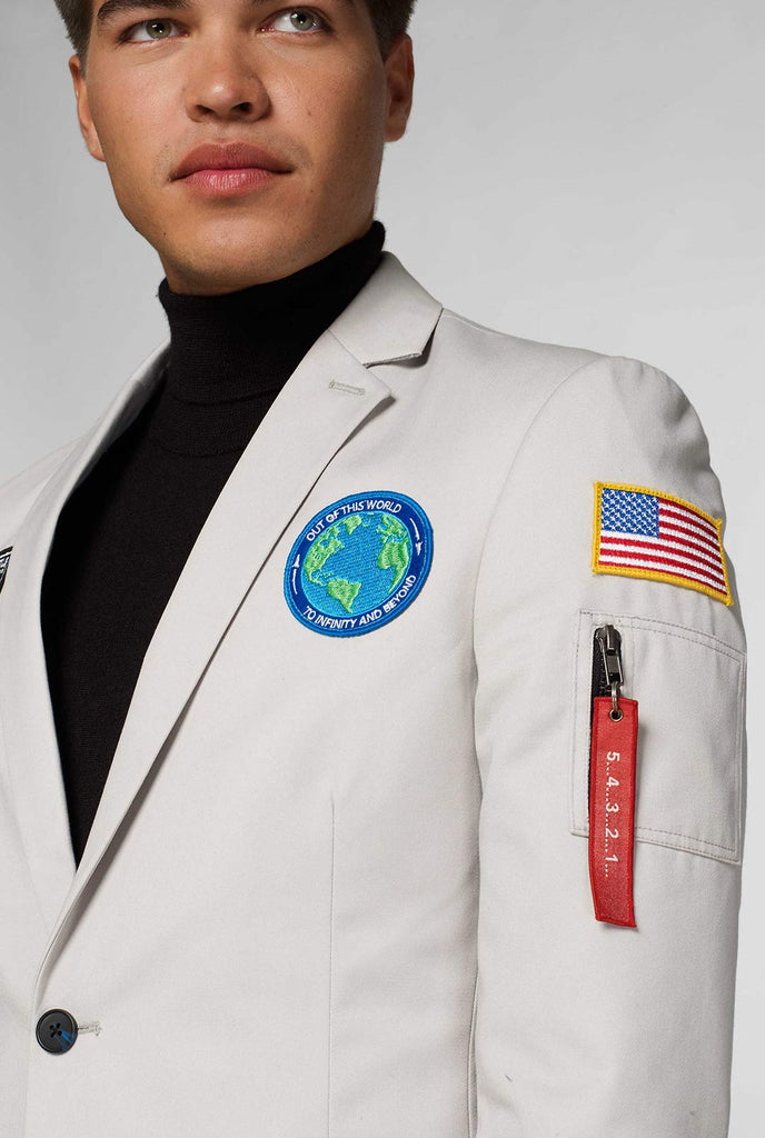 Light grey casual blazer with astronaut themed patches worn by man