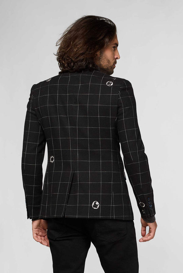 Black casual blazer with white grid pattern worn by man sitting on stool