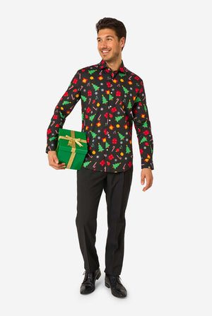 Man wearing a festive shirt with Christmas tree pattern holding a gift box on a white background