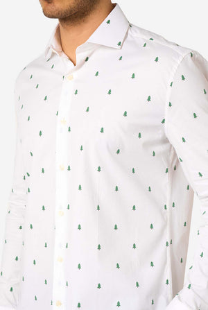 White shirt with green Christmas Tree pattern worn by a person, close up.