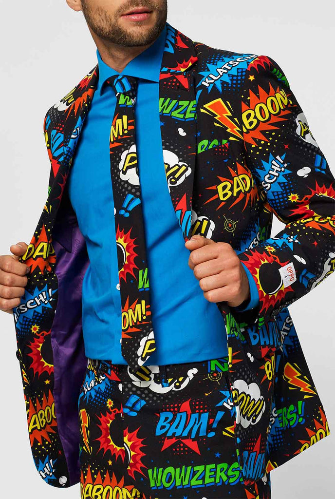 Black men's suit with comic book icons print worn by man