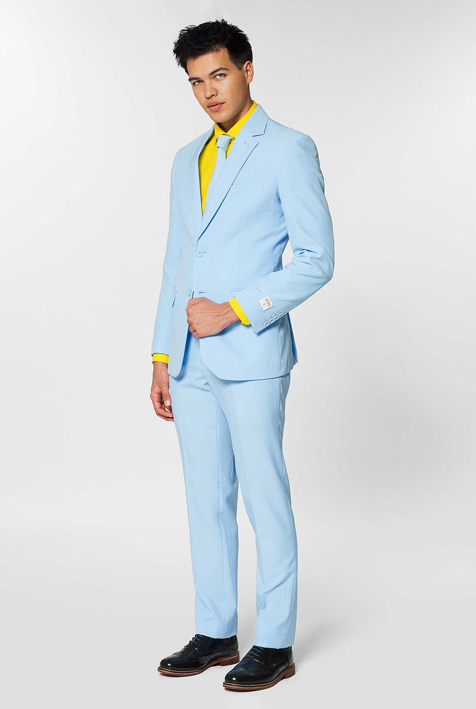 Man wearing light blue men's suit and yellow dress shirt