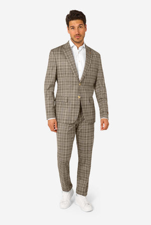 A men wearing a tan checkered suit with a white dress shirt. The suit has a modern fit with two buttons and flap pockets. He stands against a plain white background. Full body image