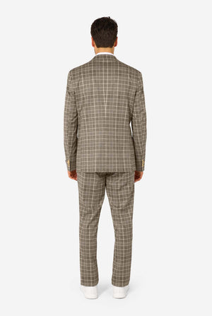 A men wearing a tan checkered suit with a white dress shirt. The suit has a modern fit with two buttons and flap pockets. He stands against a plain white background. View from the back