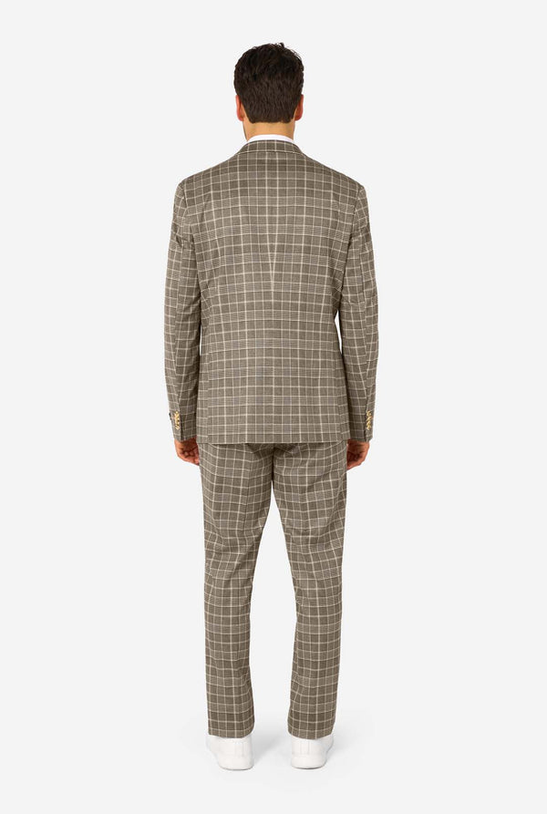 A men wearing a tan checkered suit with a white dress shirt. The suit has a modern fit with two buttons and flap pockets. He stands against a plain white background. View from the back