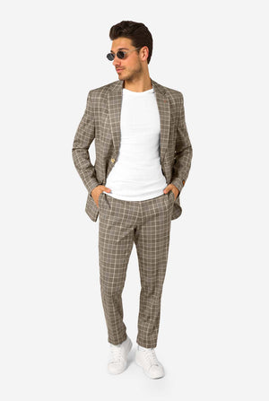 A men wearing a tan checkered suit with a white dress shirt. The suit has a modern fit with two buttons and flap pockets. He stands against a plain white background. Full body image, wearing sunglasses