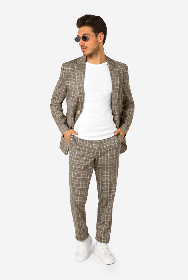 A men wearing a tan checkered suit with a white dress shirt. The suit has a modern fit with two buttons and flap pockets. He stands against a plain white background. Full body image, wearing sunglasses