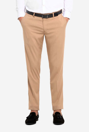 Image with light grey background and man wearing Dark Sand men’s suit and white shirt. Suits consists of blazer and pants. Focused on the pants.