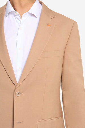 Image with light grey background and man wearing Dark Sand men’s suit and white shirt. Suits consists of blazer and pants. Focused on the chest.