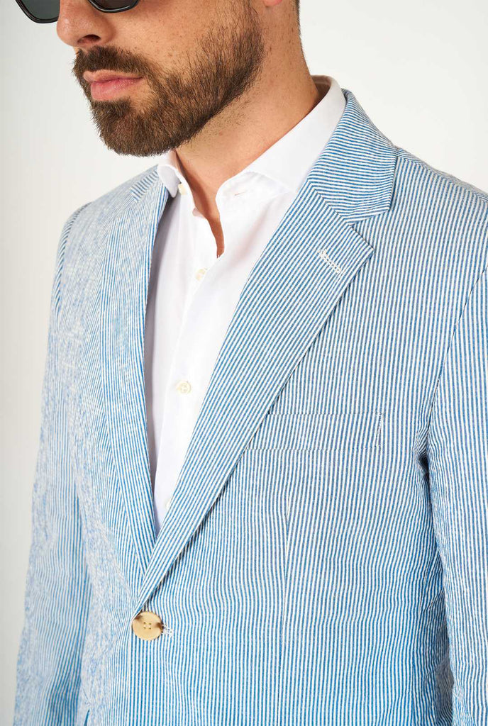 Man wearing stripped blue and white seer sucker suit