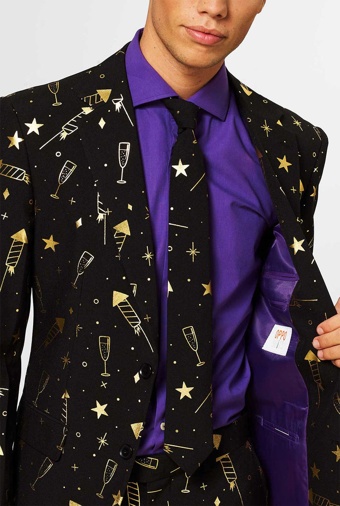 Black men's suit with golden fireworks print worn by man
