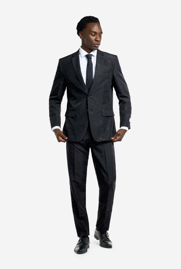 Image of a man wearing an OppoSuits Glitzy Glitter men's suit with glitters and white men's shirt. Suit consist of pants, jacket and tie.