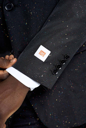 Image of a man wearing an OppoSuits Glitzy Glitter men's suit with glitters and white men's shirt. Suit consist of pants, jacket and tie.