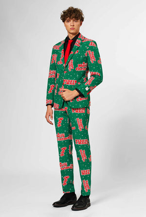 Man wearing green Christmas suit with red Christmas phrases
