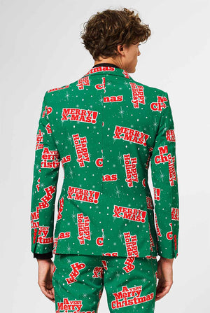 Man wearing green Christmas suit with red Christmas phrases