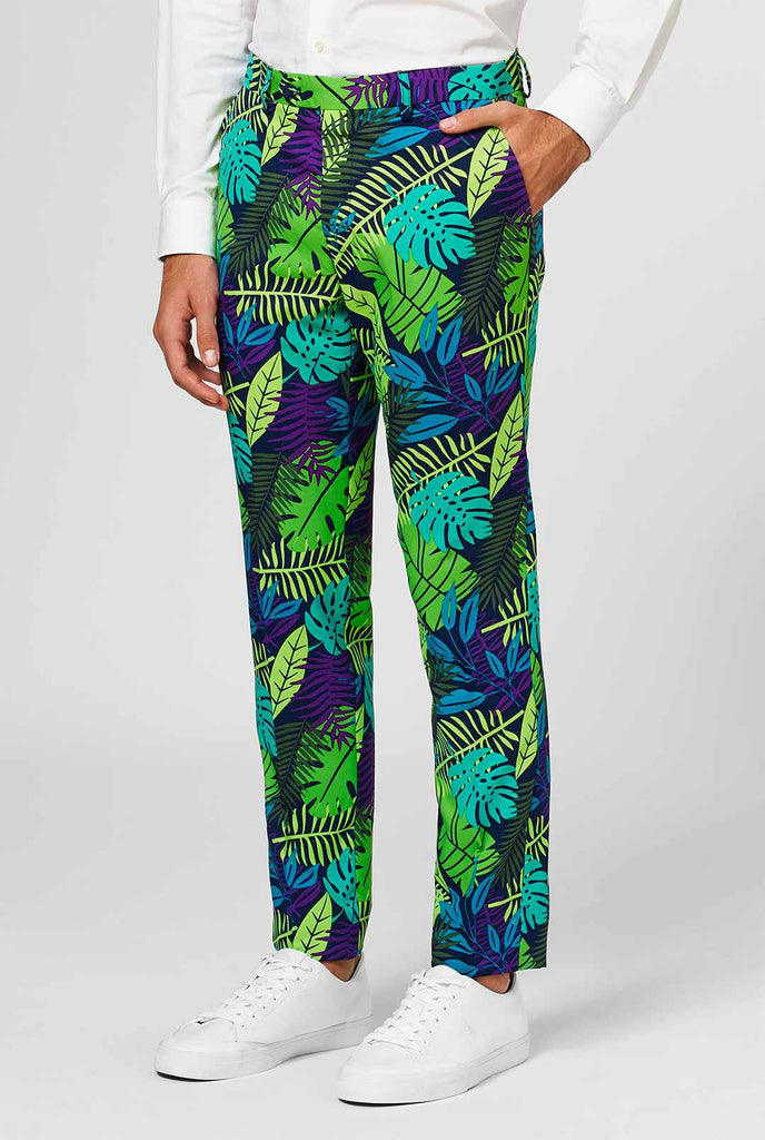 Jungle print men's suit with green and purple leaf print worn by man