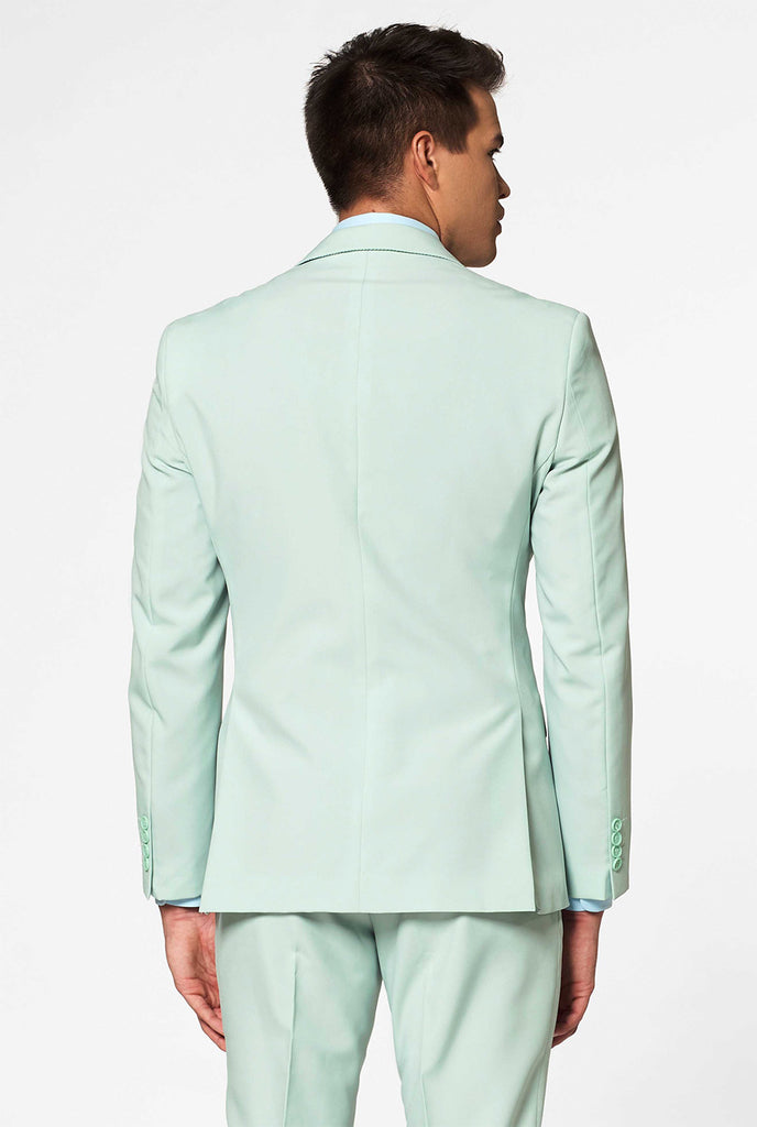 Man wearing pastel mint green colored men's suit, view from the back