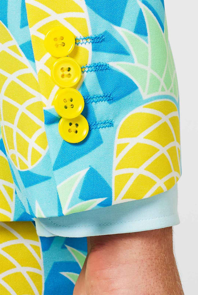 Pineapple print men's suit with bright colors by man close up