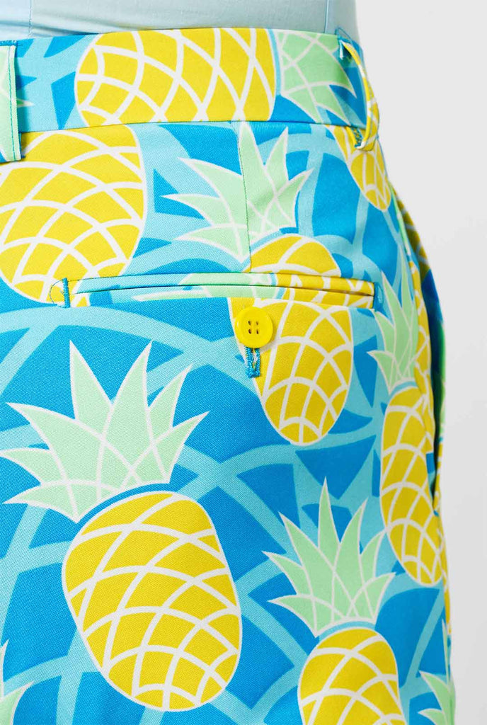 Pineapple print men's suit with bright colors by man close up