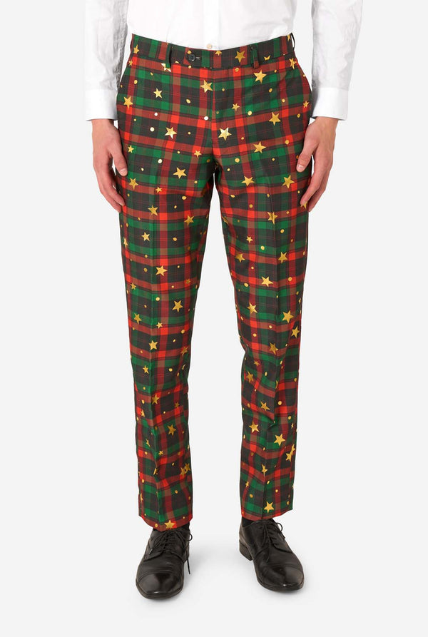 Close-up of tartan plaid suit trousers with gold star and dot accents, paired with black dress shoes.
