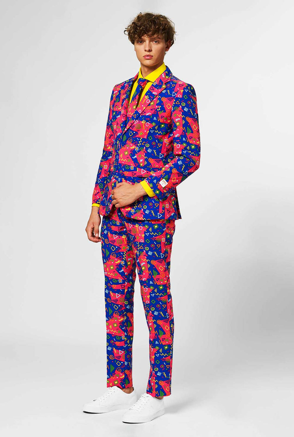Funky pink and blue men's suit with abstract icons worn by man