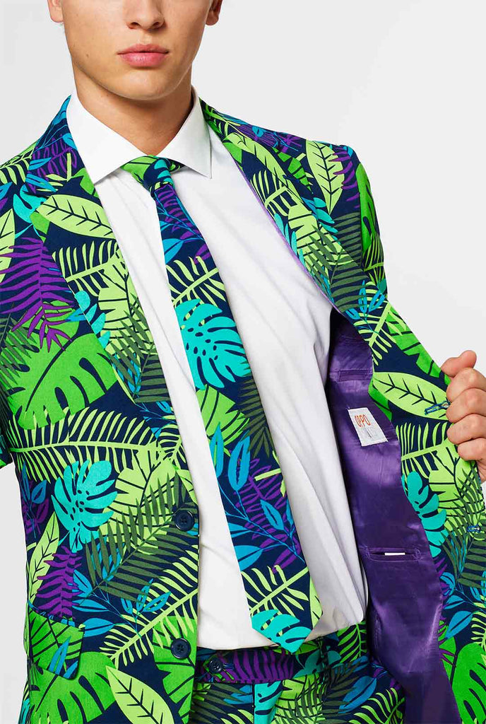 Man wearing green summer suit with jungle leaf print