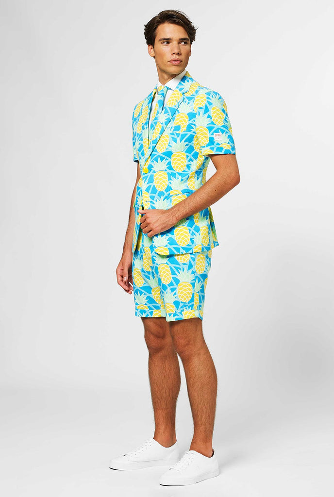 Man wearing blue summer suit with pineapple print