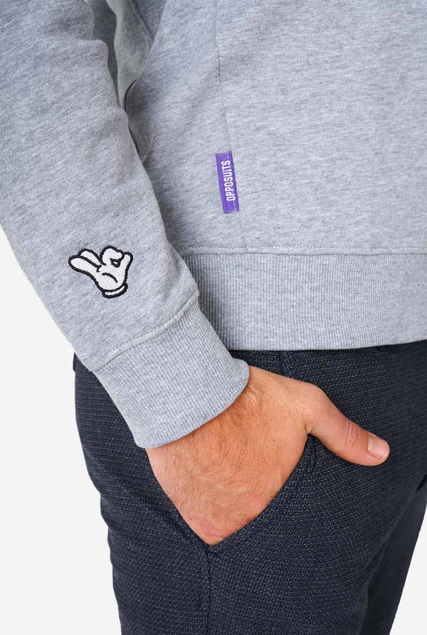 Man wearing grey sweater with chenille rock, paper, scissors embroidery