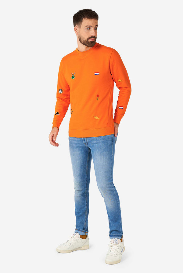 Man wearing orange sweater with Dutch icons
