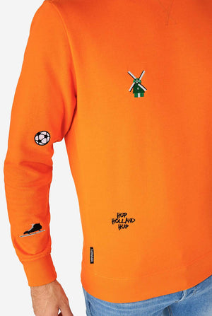 Man wearing orange sweater with Dutch icons