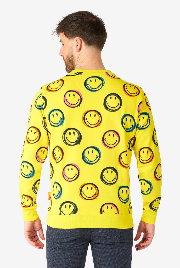 Man wearing yellow men's sweater with Smiley print