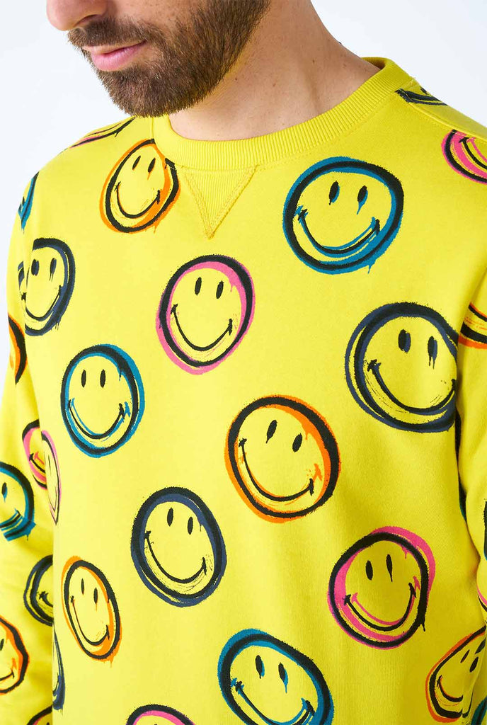 Man wearing yellow men's sweater with Smiley print