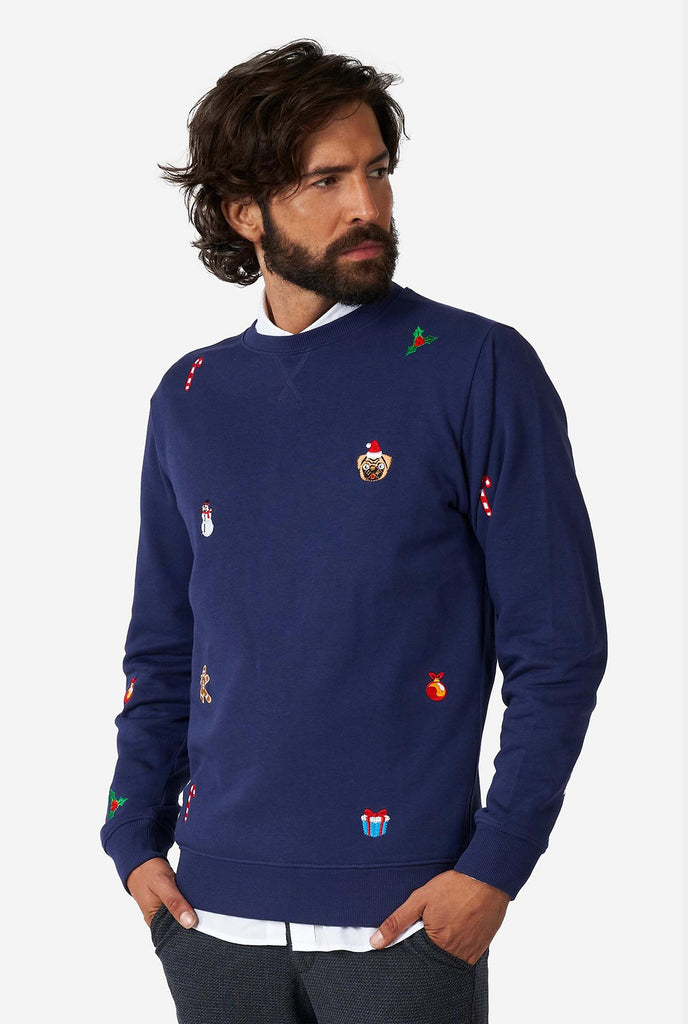 Man wearing blue Christmas sweater with Christmas icons