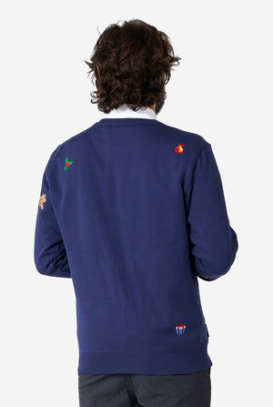 Man wearing blue Christmas sweater with Christmas icons
