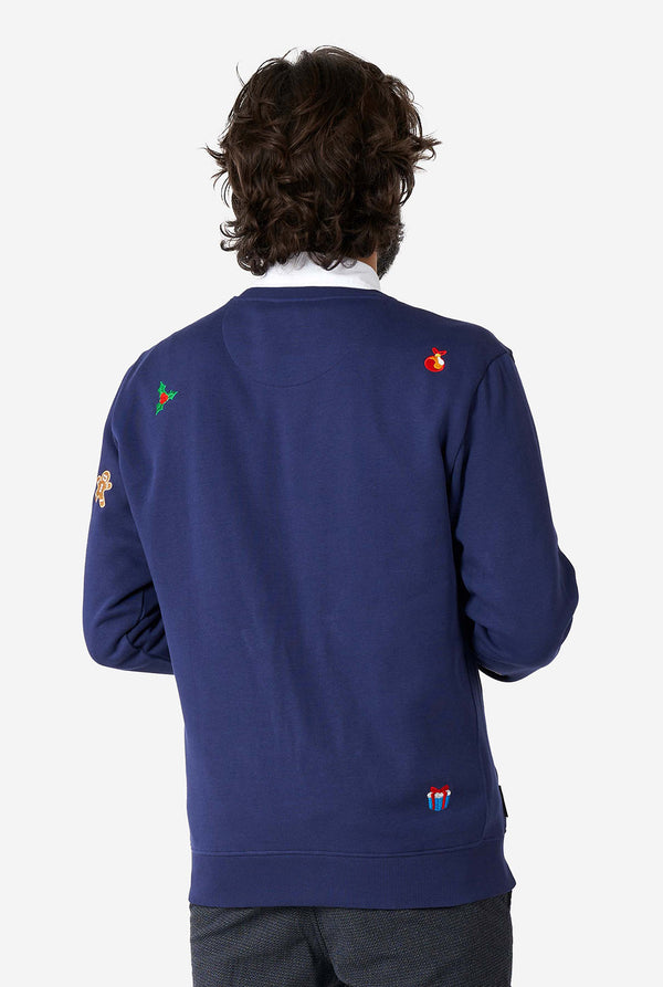 Man wearing blue Christmas sweater with Christmas icons