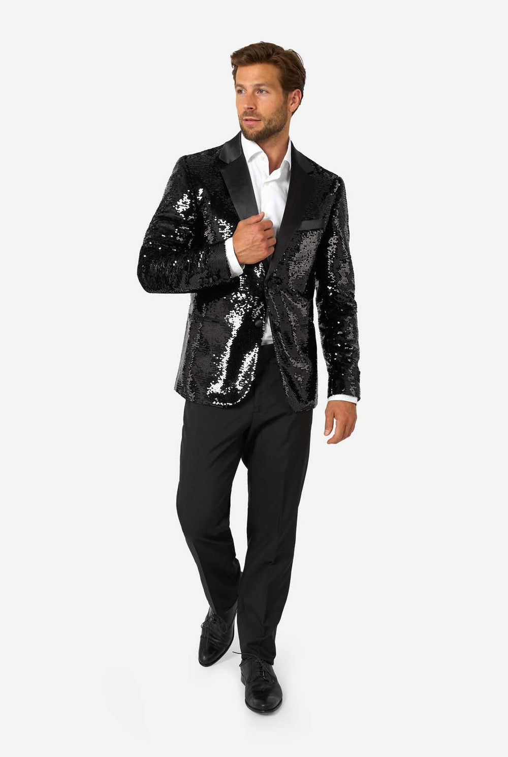 Man wearing a black sequin blazer over a white shirt on a white background